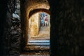 Tourists at dark medieval passage with stairs in Jewish Quarter of the old city of Girona in Catalonia, Spain Royalty Free Stock Photo