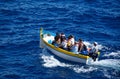 Tourists in a Maltese Dghajsa at Blue Grotto, Malta.