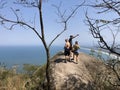 Tourists of different nationalities in line to take the picture on the rock.