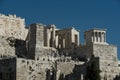 Tourists discover remains of ancient temple on hill. People on stone ruins on sunny blue sky. Travelling or vacation and