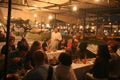 Tourists eating at outdoor food stalls