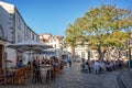 Tourists eating outdoor at restaurants terraces in summer in a picturesque square of the old town of La Rochelle France
