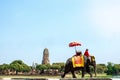 Tourists on an elephant ride tour of the ancient city at Ayutthaya, Thailand.