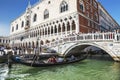 Tourists at Embankment near Palace of the doges and the Straw bridge and in gondolas, Venice