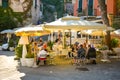 Tourists enjoy an afternoon meal on the patio of a restaurant in the resort town of Portovenere, Italy
