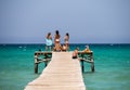 Tourists enjoy Alcudia bay sea view from a wooden jetty, Majorca