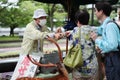 Tourists enjoy the cookies with deer on sideway. Royalty Free Stock Photo