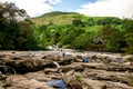 Tourists enjoy falls of Dochart view and hill landscape in a town of Killin