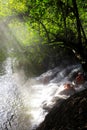 Tourists enjoy a hot spring waterfall in thailand