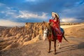 Tourists enjoy ride horses in Cappadocia, Turkey.