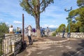 Tourists enjoy a street musician as they overlook Nice, France from Castle Hill