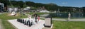 Tourists enjoy summer activities on the lakeshore in Arosa with the train and cable railway station in the background Royalty Free Stock Photo