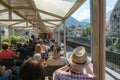 Tourists enjoy traveling in the open panorama carriage from Chur to Arosa Royalty Free Stock Photo