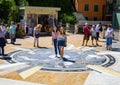 Tourists enjoying a beautiful mosaic in Manarola, northern Italy.