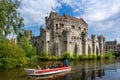 Tourists enjoying a boat ride on the river near Gravensteen castle