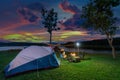 Tourists enjoying camping by the lake