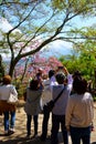 Tourists enjoying cherry blossoms in Japan, makes a photo Mt Fuji. Japanese landscape.