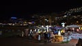 Tourists enjoying dinner at restaurant near the beach of Puerto Rico, Gran Canaria, Spain in the evening. Royalty Free Stock Photo