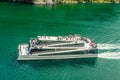 Tourists are enjoying magnificent view of Fjord on board of ferry boat in Norway