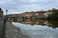 Florence city with tourists enjoying view on the Arno river in Italy Royalty Free Stock Photo