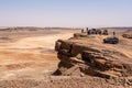 Tourists enjoying the scenic view of the Sahara desert from mount Gara Medouar
