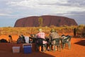 Couple enjoys the sunset at Ayers Rock and has a picknick, Australia Royalty Free Stock Photo