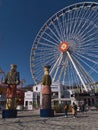 Tourists enjoying their time in park Wurstelprater near Wiener Prater in Vienna, Austria with tall ferris wheel Blumenrad. Royalty Free Stock Photo