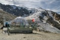 Tourists enjoying time in mountain bar with nice views on glacier in Hohsaas above the Saas-Grund village, Switzerland