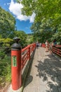 Tourists enjoying the view from Kaedebashi Bridge over the Kitamata river.