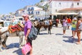 Tourists enjoying the view of the port of the Greek island of Poros, Greece