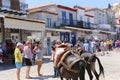 Tourists enjoying the view of the port of the Greek island of Poros, Greece
