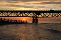 Tourists enjoying the view of sunset by Lake Michigan under Mackinac Bridge Royalty Free Stock Photo