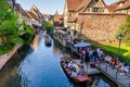 Tourists enjoying water boat trips in Lauch river in Colmar, France, Europe Royalty Free Stock Photo