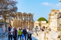 Tourists in the Ephesus and Library of Celsus on the background. Royalty Free Stock Photo