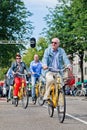 Tourists explore city on rental bike, Amsterdam, Netherlands