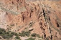 Tourists explore the dramatic landscape of the Fairy Tale Canyon, or Skazka Canyon in Kyrgyzstan