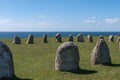 Tourists explore Gettlinge grave field with its famous stone ship in Gettlinge. The oldest graves date back to the Nordic bronze Royalty Free Stock Photo