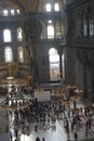 Tourists explore the vast interior of Hagia Sophia