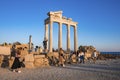 Tourists exploring old ruins of the Temple of Apollo at coastline during sunset Royalty Free Stock Photo