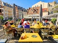 Tourists and fans of the Ice Hockey World Championship 2023 drink beer on the open veranda