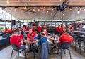 Tourists and fans of the World Basketball Championship 2023 drink beer on the open veranda of cafes Royalty Free Stock Photo