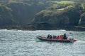 Tourists in fast inflatable boat to Lundy Island in Devon