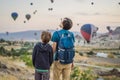 Tourists father and son looking at hot air balloons in Cappadocia, Turkey. Happy Travel in Turkey concept. father and Royalty Free Stock Photo