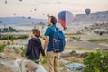 Tourists father and son looking at hot air balloons in Cappadocia, Turkey. Happy Travel in Turkey concept. father and Royalty Free Stock Photo