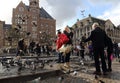 Tourists feed the pigeons in Amsterdam, Holland
