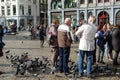 Tourists feed the pigeons in Piazza Amsterdam, Holland