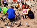 Tourists feeding Batu Caves pigeons