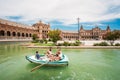 Tourists float on a boat on the canal promenade