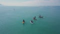 Tourists floating on SUP Board in blue sea. Clip. Top view of group of people on SUP-Boards floating in quiet clear sea