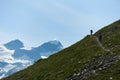 Tourists following path in mountains. Royalty Free Stock Photo